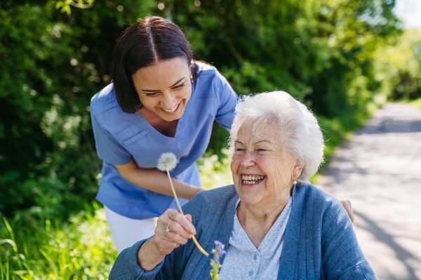 assisted-living-caregiver-elderly-woman-outdoor-care-1